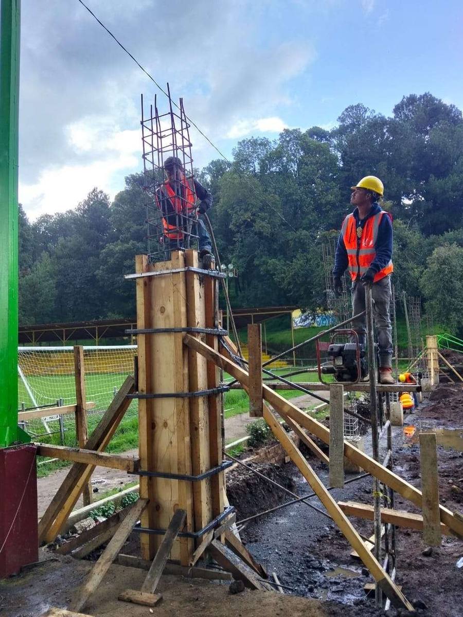 Cimbra de columnas de concreto con trabajadores en obra